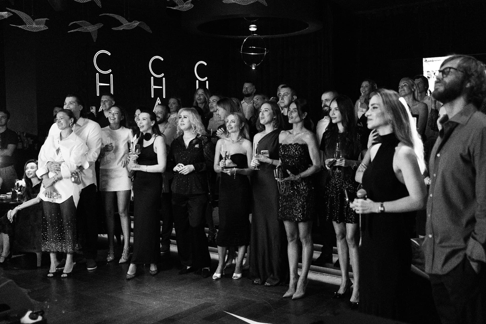 A black-and-white group photograph at an SPI Dubai evening